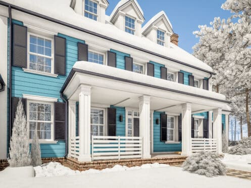 Colonial style home with snow on the roof