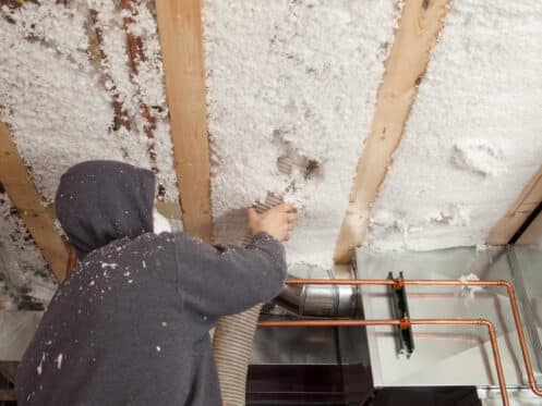 Blown insulation being blown.